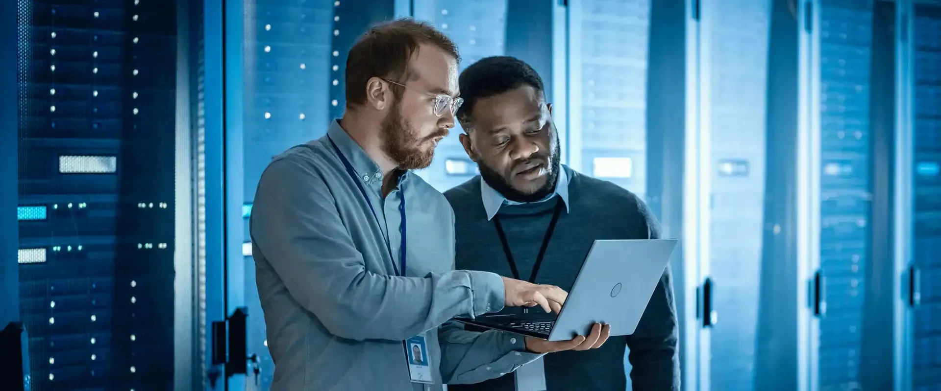 Two Epoch engineers reviewing a laptop in a server room